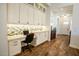 Dedicated office space with custom cabinetry, built-in desk, and stylish backsplash at 19777 E Ivy Ln, Queen Creek, AZ 85142