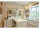 Well-organized office with custom cabinets, built-in shelving, desk, and window bench at 19777 E Ivy Ln, Queen Creek, AZ 85142