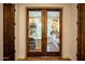 Bright office with custom built-ins and stylish glass panel wooden door at 19777 E Ivy Ln, Queen Creek, AZ 85142