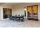 A covered patio with a dining table set for eight provides an inviting outdoor space for entertaining and enjoying meals at 19777 E Ivy Ln, Queen Creek, AZ 85142