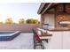 Outdoor kitchen with brick accents, bar seating and stainless steel appliances at 19777 E Ivy Ln, Queen Creek, AZ 85142