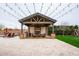 Gorgeous outdoor pavilion with a brick fireplace and built in grill, set in a meticulously manicured backyard at 19777 E Ivy Ln, Queen Creek, AZ 85142