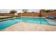 Outdoor pool featuring a basketball hoop, volleyball net, and a table with chairs under an umbrella at 19777 E Ivy Ln, Queen Creek, AZ 85142