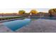 An outdoor pool area featuring a volleyball net, basketball hoop, and an umbrella-shaded table at 19777 E Ivy Ln, Queen Creek, AZ 85142