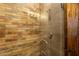 Walk-in shower featuring glass door, unique tile and chrome fixtures at 19777 E Ivy Ln, Queen Creek, AZ 85142