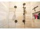 Walk in shower features a dual shower head, tile surround, and built in niche at 19777 E Ivy Ln, Queen Creek, AZ 85142
