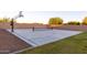 A backyard sport court offers a fun space for basketball and tennis and a healthy, active lifestyle at 19777 E Ivy Ln, Queen Creek, AZ 85142