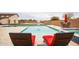 Resort-style swimming pool and spa area with lounge chairs, a volleyball net, and meticulously landscaped surroundings at 19777 E Ivy Ln, Queen Creek, AZ 85142