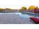 Large swimming pool with sunning area and a view of the backyard featuring a volleyball net at 19777 E Ivy Ln, Queen Creek, AZ 85142