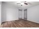 Neutral bedroom with a ceiling fan, dark wood-look floors, and light gray walls at 2400 E Baseline Ave # 278, Apache Junction, AZ 85119