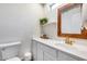 Bright bathroom with white cabinets, gold faucet, and decorative mirror that offers natural light at 2402 E 5Th St # 1742, Tempe, AZ 85288
