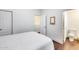 Spacious bedroom with adjoining bathroom features wood floors, white walls and a large window at 2402 E 5Th St # 1742, Tempe, AZ 85288