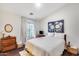 Inviting bedroom with a cozy bed, hardwood floors, dresser, and ample natural light from the window at 2402 E 5Th St # 1742, Tempe, AZ 85288
