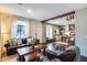 Inviting living room with hardwood floors, natural light, and kitchen in the background at 2402 E 5Th St # 1742, Tempe, AZ 85288
