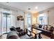 Bright living room featuring leather seating, a large sectional, hardwood floors, and plenty of natural light at 2402 E 5Th St # 1742, Tempe, AZ 85288