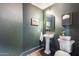 Dark green powder room showcasing a pedestal sink, ornate mirror, toilet, and stylish wall decor at 2402 E 5Th St # 1742, Tempe, AZ 85288