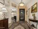 Elegant entryway with decorative rug, chandelier, and views into the adjacent living spaces at 24111 S Lakeway Nw Cir, Sun Lakes, AZ 85248