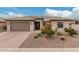 Charming single-story home with desert landscaping, a two-car garage and tile roof at 24111 S Lakeway Nw Cir, Sun Lakes, AZ 85248