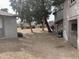 View of the home's backyard with a large gravel area, mature trees, and tasteful landscaping at 244 E Ponderosa Ln, Phoenix, AZ 85022