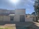 Exterior elevation of the two-story townhome featuring desert landscaping, covered walkway and wrought iron gate at 244 E Ponderosa Ln, Phoenix, AZ 85022