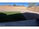 A backyard with artificial turf, gravel, and a block wall fence creating a private outdoor space at 2486 E Espada Trl, Casa Grande, AZ 85194