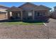 The home has an expansive backyard with artificial grass, a covered patio, and a built-in outdoor grill area at 2486 E Espada Trl, Casa Grande, AZ 85194