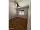 Inviting bedroom with wood flooring, ceiling fan, and a window offering natural light at 2486 E Espada Trl, Casa Grande, AZ 85194