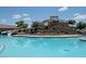 A community pool with a splash pad and a slide creating a fun and Gathering-friendly atmosphere at 2486 E Espada Trl, Casa Grande, AZ 85194