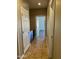 Hallway featuring tiled floors, neutral walls, white doors, and a built-in cabinet at 2486 E Espada Trl, Casa Grande, AZ 85194