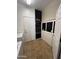 Well-organized laundry room with chalkboard wall, tile flooring and white cabinets at 2486 E Espada Trl, Casa Grande, AZ 85194