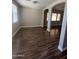 An open-concept living room with wood-look floors and large windows at 2486 E Espada Trl, Casa Grande, AZ 85194