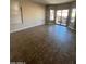 Bright and airy living room featuring tile floors and sliding glass doors to the backyard patio at 2486 E Espada Trl, Casa Grande, AZ 85194