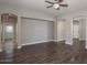 Spacious living room with hardwood floors, neutral walls, and decorative ceiling fan at 2486 E Espada Trl, Casa Grande, AZ 85194