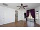 Spacious main bedroom boasting hardwood floors, a ceiling fan, and a walk out door at 2486 E Espada Trl, Casa Grande, AZ 85194