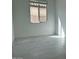 Cozy bedroom featuring tile flooring and a window providing natural light at 25330 W Bowker St, Buckeye, AZ 85326