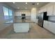 Spacious kitchen with stainless steel appliances, granite countertops, and a large central island at 25330 W Bowker St, Buckeye, AZ 85326