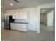Kitchen area featuring stainless steel appliances, white cabinetry, and tile floors at 25330 W Bowker St, Buckeye, AZ 85326