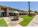 Apartment complex showcasing outdoor seating and manicured lawns, offering a serene and welcoming environment at 2605 W Rose Ln # B101, Phoenix, AZ 85017