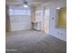 Bright living room featuring a large window, neutral-toned walls, ceiling fan, and a portable kitchen island at 2605 W Rose Ln # B101, Phoenix, AZ 85017