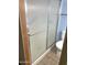 Bathroom featuring a shower with a textured sliding door at 2605 W Rose Ln # B101, Phoenix, AZ 85017
