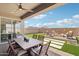 Inviting outdoor living space with a covered patio, dining table, seating area with a fire pit, and mountain views at 26388 N 77Th Dr, Peoria, AZ 85383