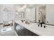 Bright bathroom featuring a double vanity with matte black fixtures and mirrors with access to the bedroom and a shower at 26388 N 77Th Dr, Peoria, AZ 85383