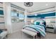 Stylish bedroom with blue and white striped walls, contemporary furnishings, and ample natural light at 26388 N 77Th Dr, Peoria, AZ 85383