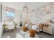 Charming bedroom featuring stylish decor with decorative wall art, a rattan daybed, and a cozy workstation at 26388 N 77Th Dr, Peoria, AZ 85383