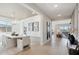 Elegant dining area with modern chandelier, light wood floors, and ample seating for Gathering gatherings at 26388 N 77Th Dr, Peoria, AZ 85383