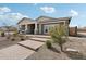 Beautiful home with a covered front porch, stone accents, and brick paver walkway, enhancing its curb appeal at 26388 N 77Th Dr, Peoria, AZ 85383