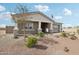 Inviting home with desert landscaping, featuring a covered front porch and classic architectural design elements at 26388 N 77Th Dr, Peoria, AZ 85383