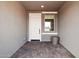 Covered entryway features brick pavers, neutral paint, and a convenient spot for seating at 26388 N 77Th Dr, Peoria, AZ 85383