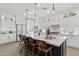 Beautiful white kitchen featuring a large island with barstool seating and modern appliances, and ample cabinet storage at 26388 N 77Th Dr, Peoria, AZ 85383