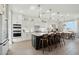 Modern white kitchen featuring stainless steel appliances, a central island with seating, and sleek countertops at 26388 N 77Th Dr, Peoria, AZ 85383
